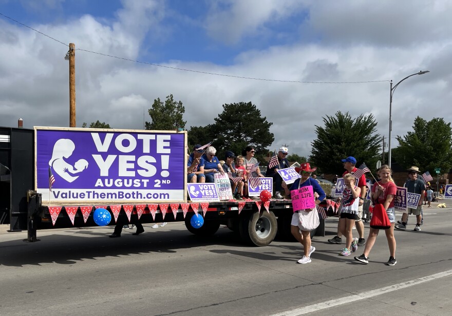 Proponents of the constitutional amendment walk along a parade route in Hays.